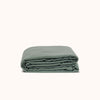 A folded duvet cover in a matte green color, representing the product's soft texture and solid color design.