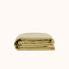 Folded green duvet cover on a white background